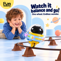 Boy watching a single-wheel space robot balance on a track