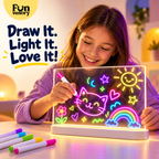 Girl drawing glowing pictures on an LED light-up drawing board