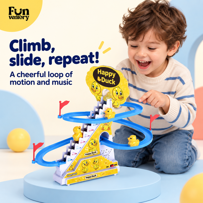 Boy watching ducks climb and slide on a musical duck track toy
