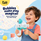 Boy laughing while blowing bubbles with a whale bubble gun